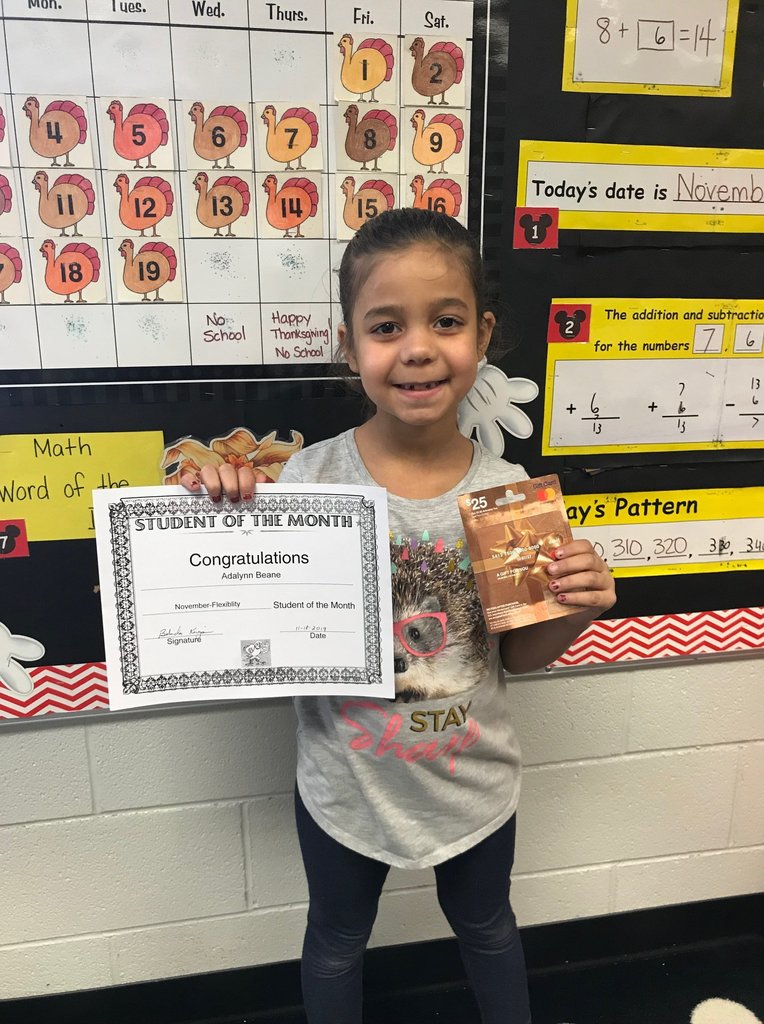 Adalynn Beane holding Student of the Month certificate